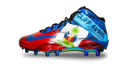 Left side of Avril's red and blue cleat with writing - Cliff Avril Family Foundation and the Haiti flag coat of arms