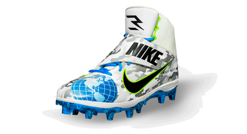 Left front view of Wilson's cleat, with blue globe on front and grey camo pattern and the Nike logo