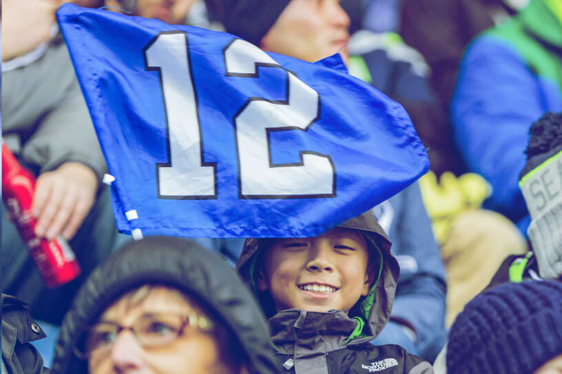 A young Seahawks fan holds up a 12 flag