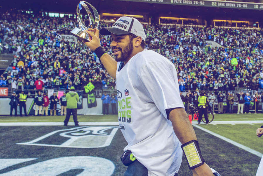 Russell Wilson holds up the Lombardi Trophy at Super Bowl 48